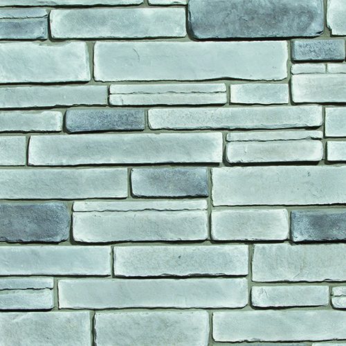 Gray-blue stacked stone wall with horizontally arranged rectangular stones of varying lengths and textures.