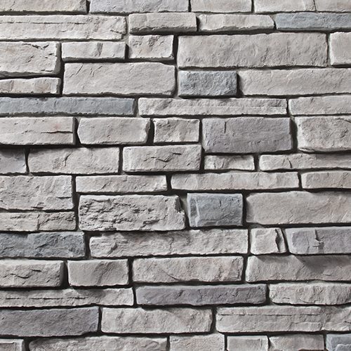 Close-up of a gray stacked-stone wall with rectangular blocks