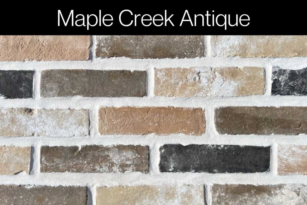 Antique brick in beige, brown, and charcoal hues with a delicate white finish, blending rustic and modern appeal.