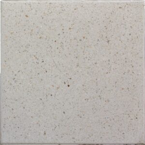 Light beige terrazzo tile with small brown and gray flecks, close-up texture pattern.